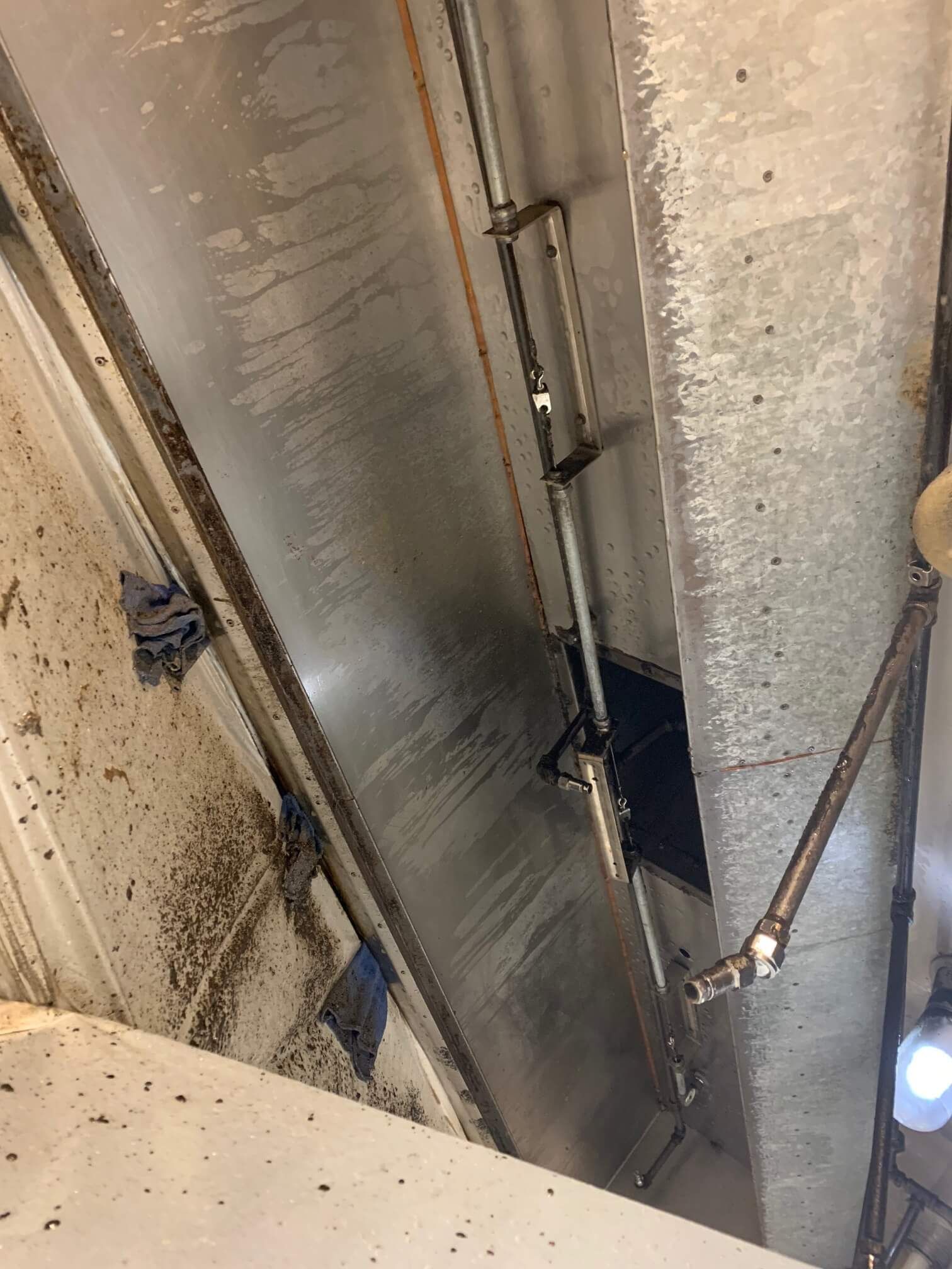 A dirty room with a lot of bugs on the floor and ceiling.