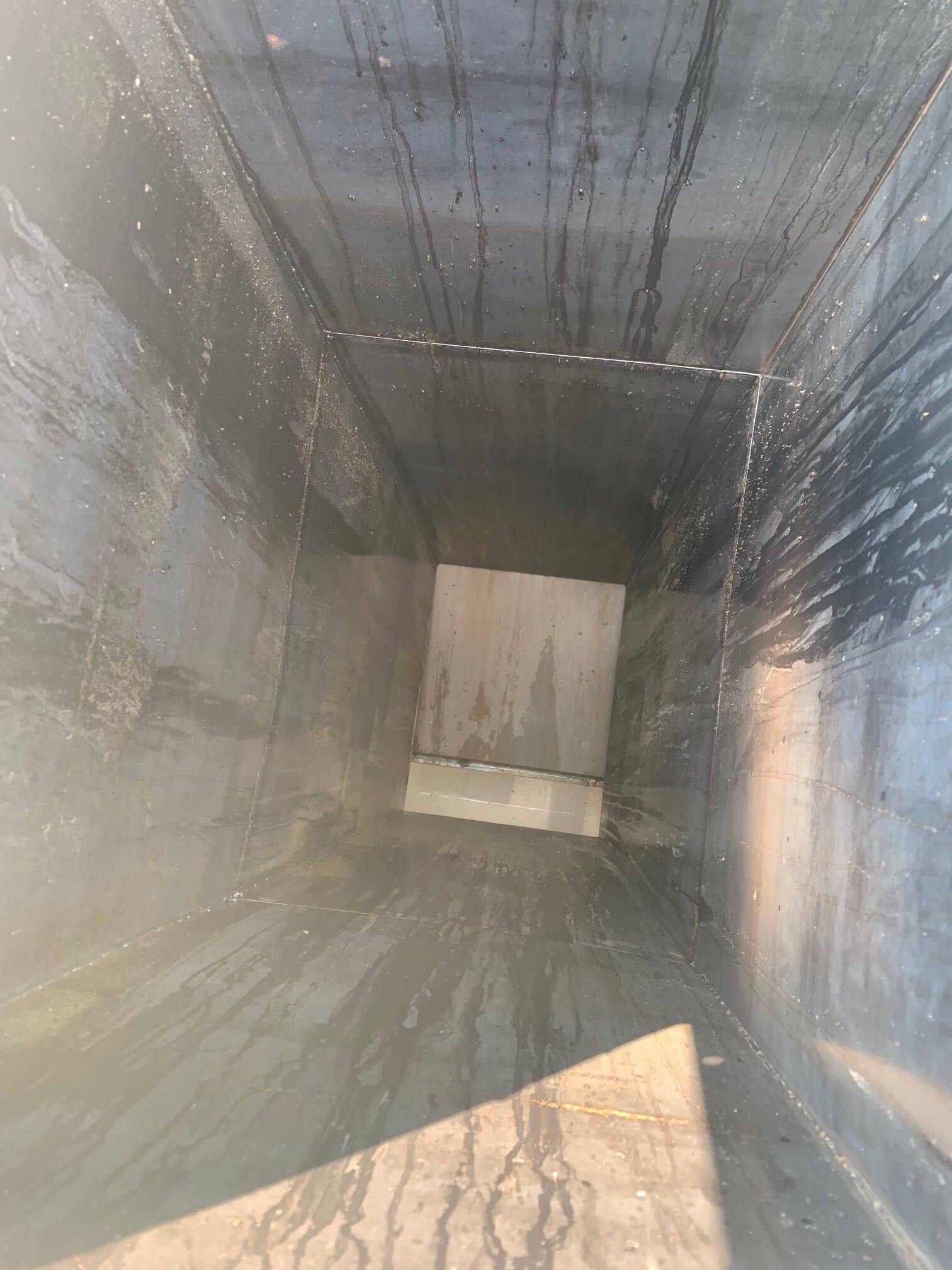 Looking down a narrow vent in a building.