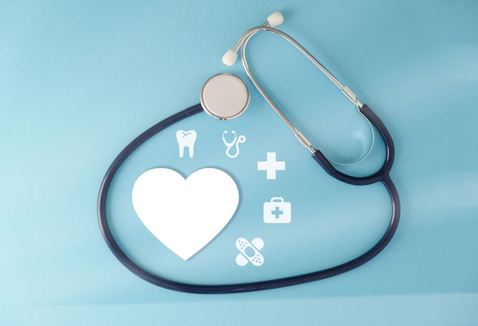 A stethoscope is surrounded by medical icons on a blue background.