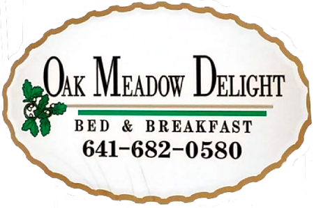 Logo for Oak Meadow Delight Bed & Breakfast, featuring text and a green oak leaf icon inside an oval, scalloped border.