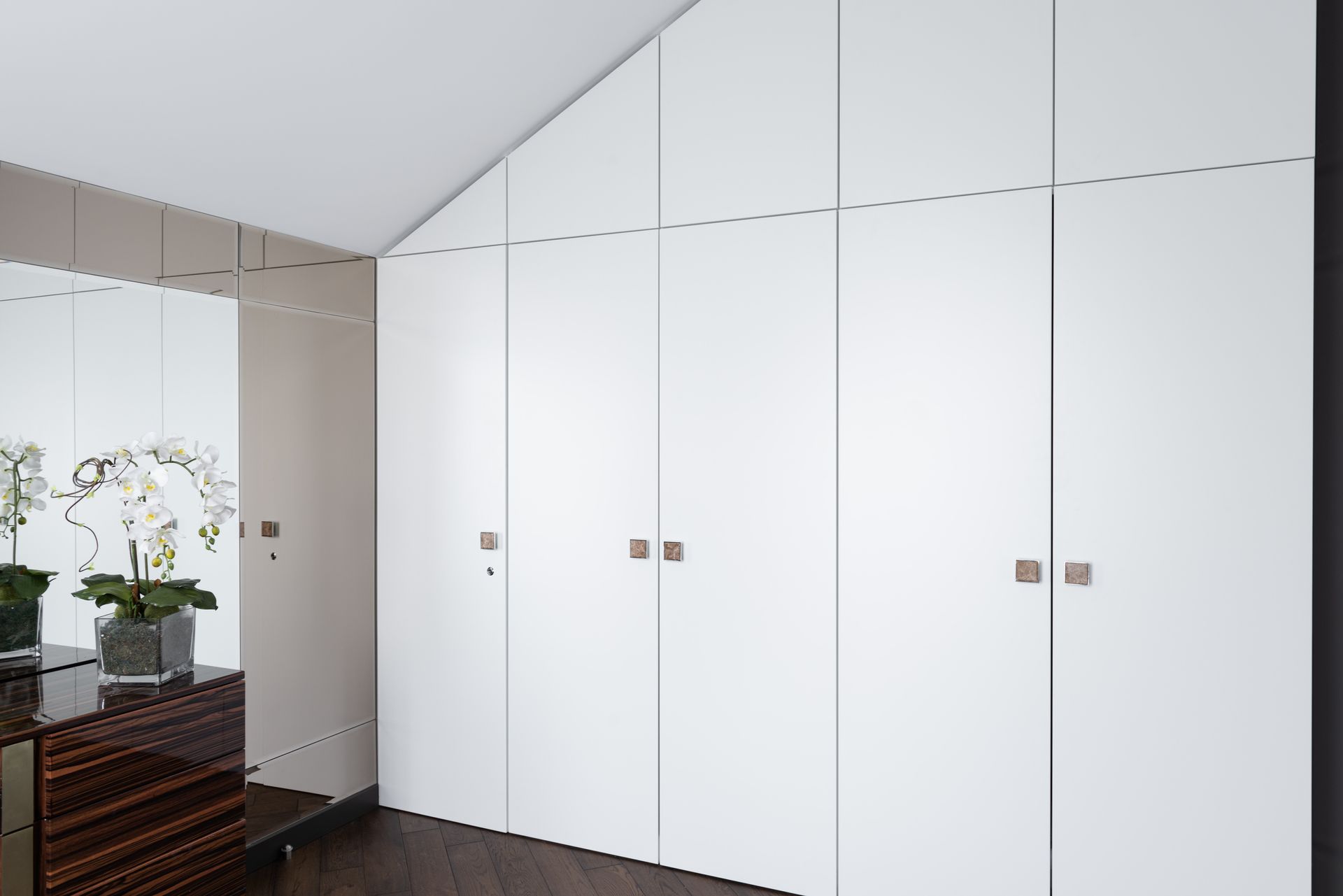 A white wardrobe in a spacious room.