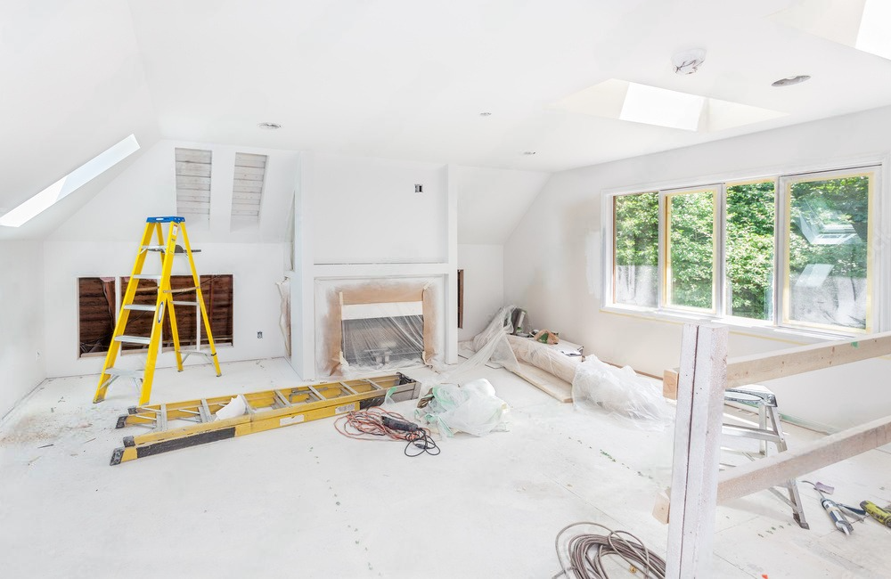 a room under construction with a yellow ladder on the floor