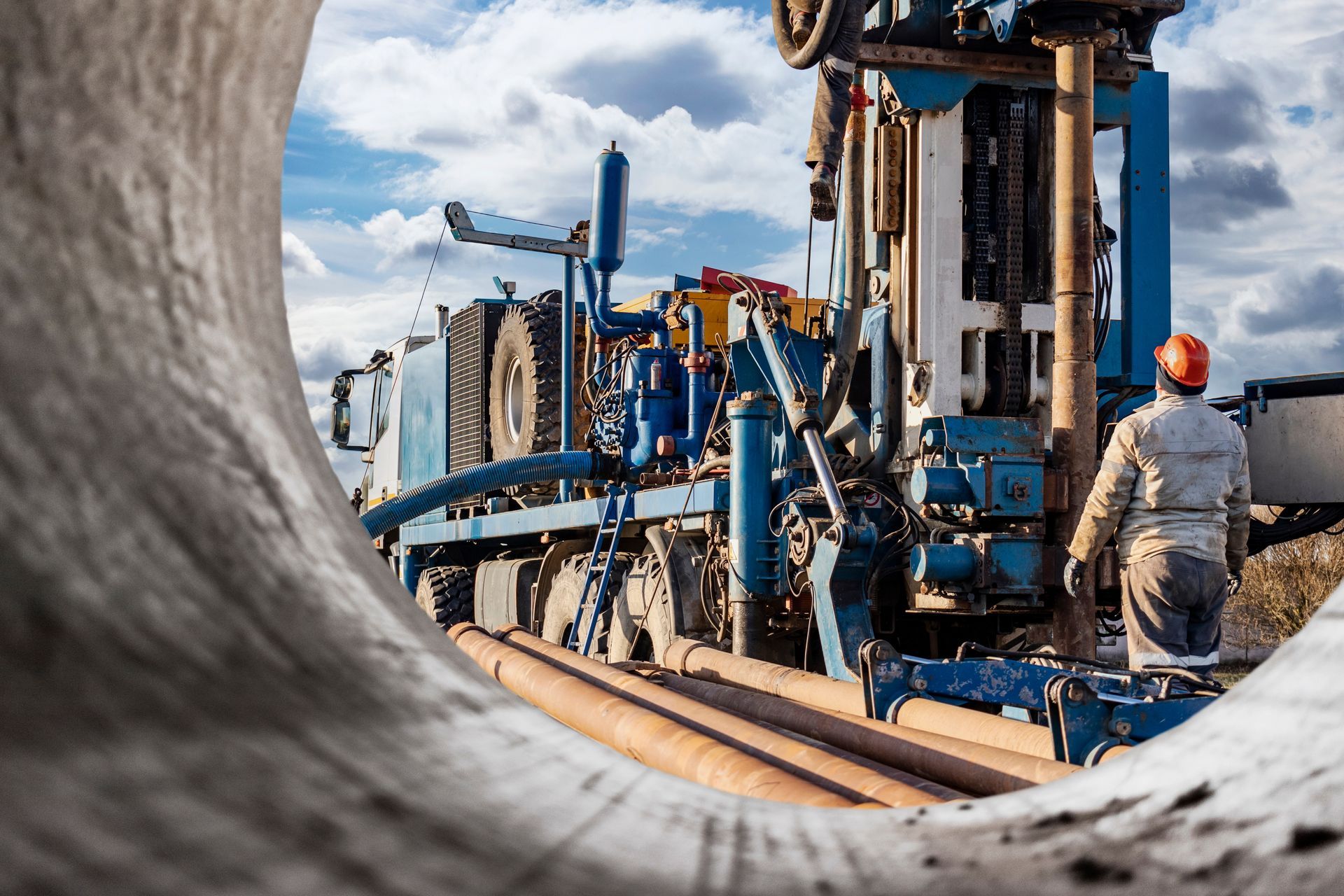 Drilling rig next to a worker