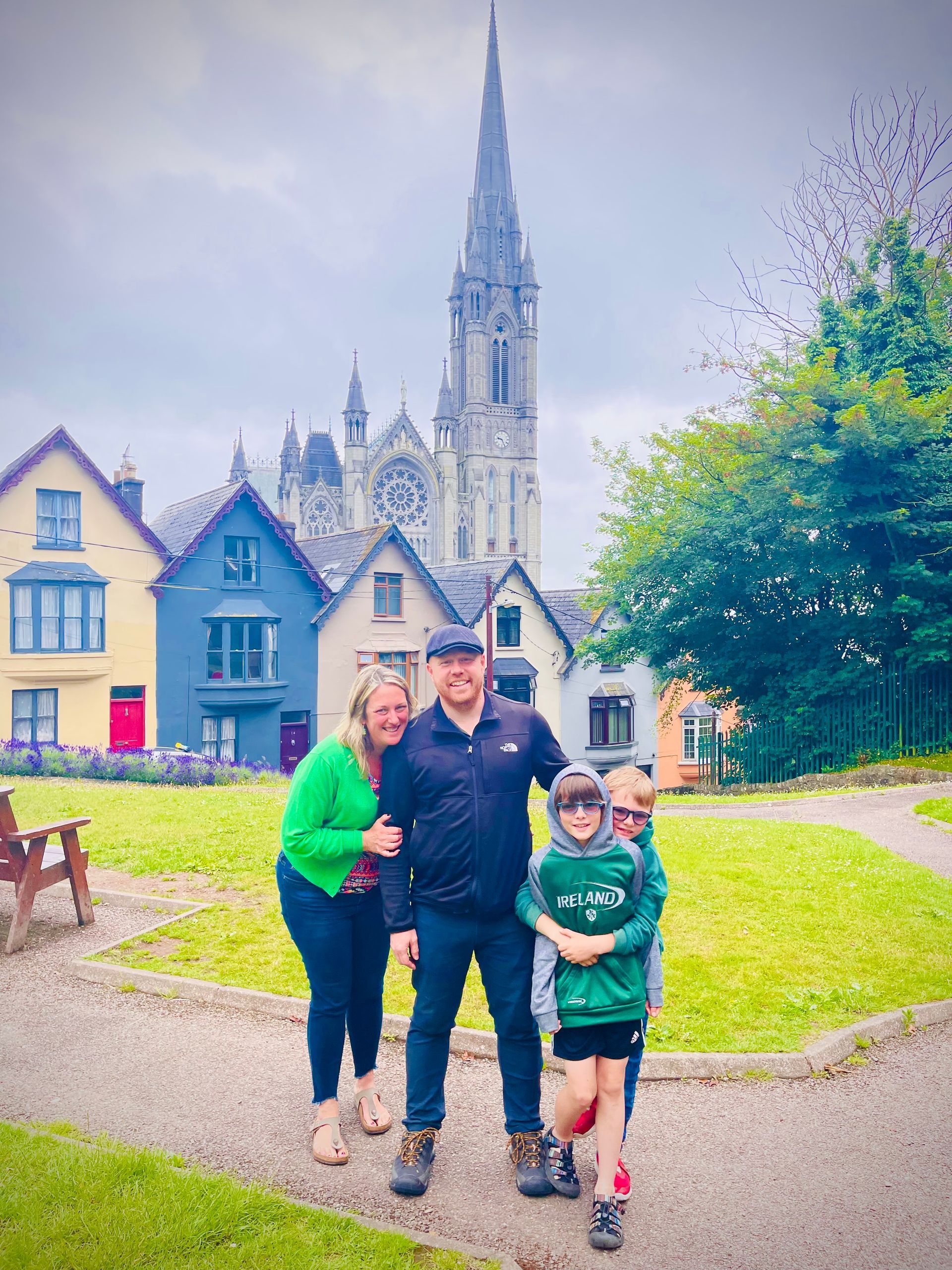 a family is posing for a picture in front of a church .
