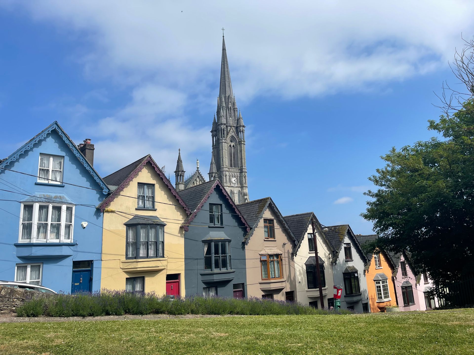 a row of houses with a church in the background