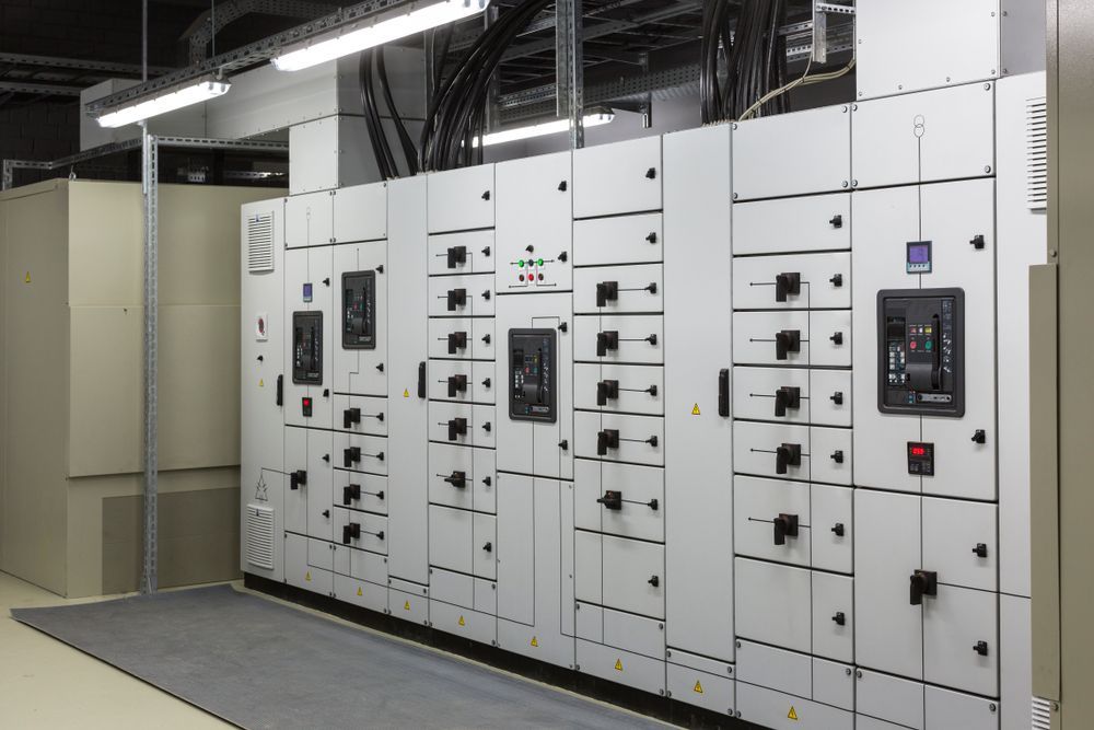 Electrical Control Panels in a Well-lit Room With Cables Overhead — FAW Electrical in Berry, NSW