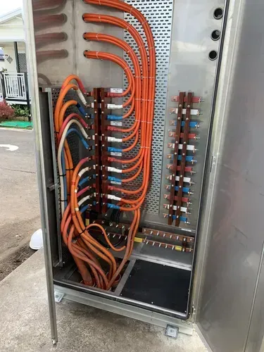 Metal Electrical Cabinet With Orange and Blue Cables — FAW Electrical in Nowra Hill, NSW