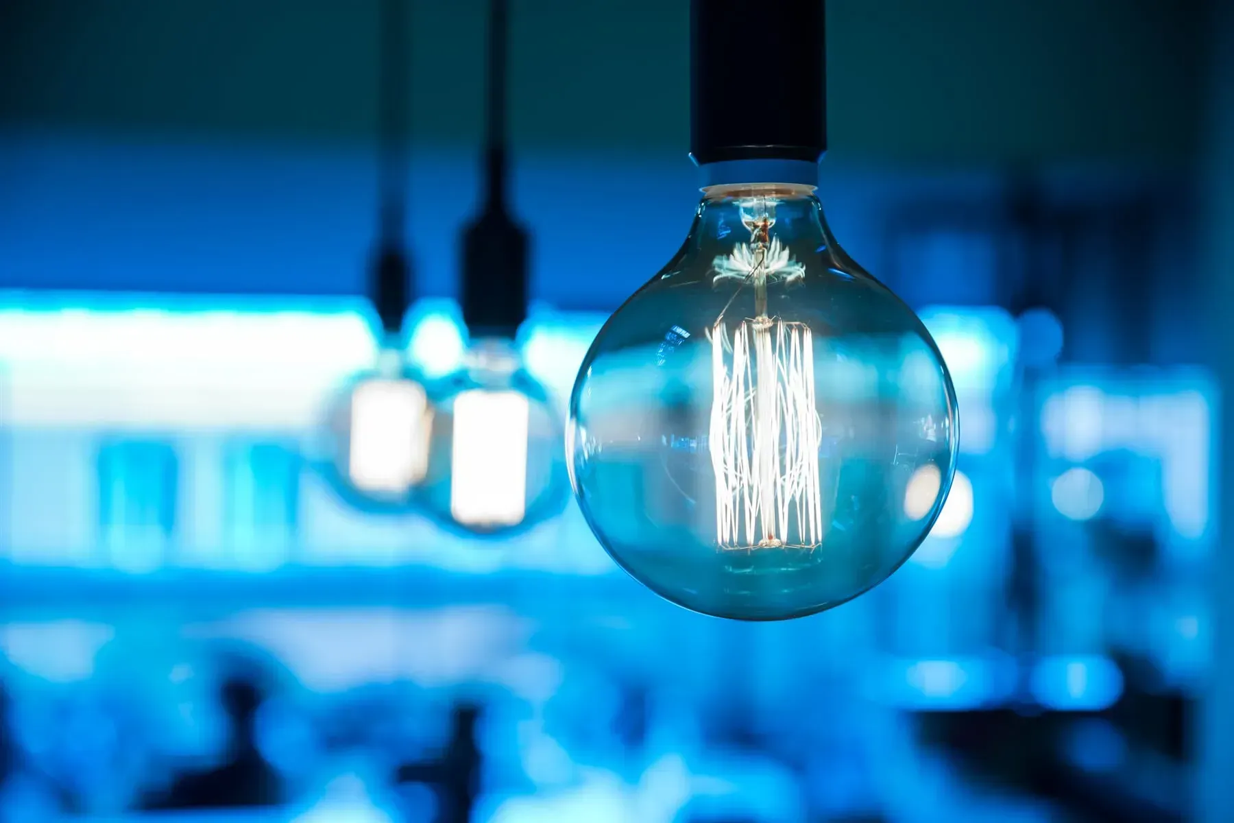 Close-up of a Lit, Clear Light Bulb Hanging From a Ceiling — FAW Electrical in Nowra Hill, NSW
