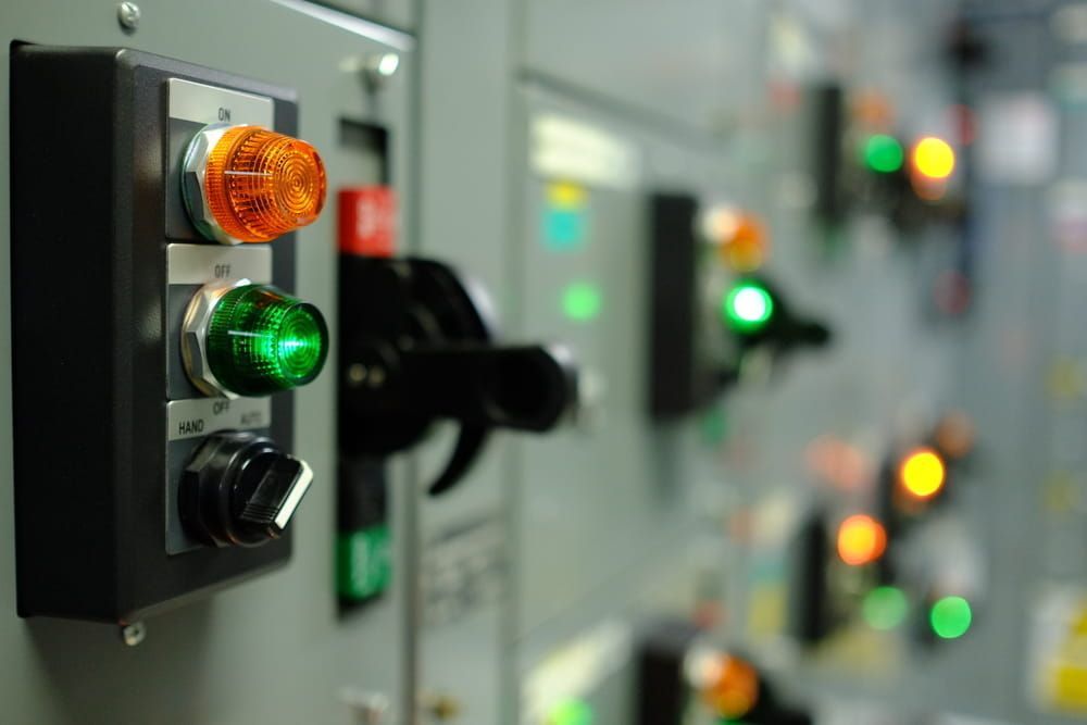 Control Panel With Orange and Green Indicator Lights Illuminated, Along With Switches — FAW Electrical in Callala Beach, NSW