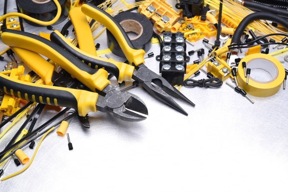 Yellow and Black Electrician's Tools and Supplies on a Metal Surface — FAW Electrical in Ulladulla, NSW