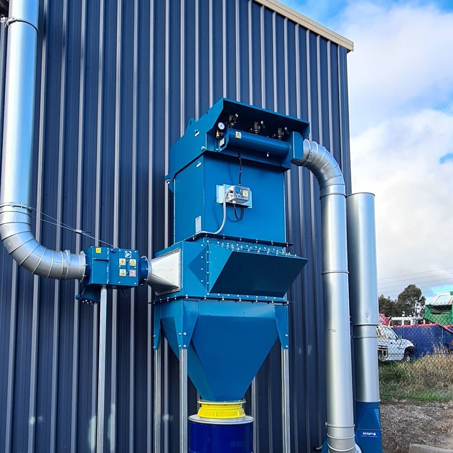Blue Industrial Dust Collector Mounted on a Dark Blue — FAW Electrical in Berry, NSW