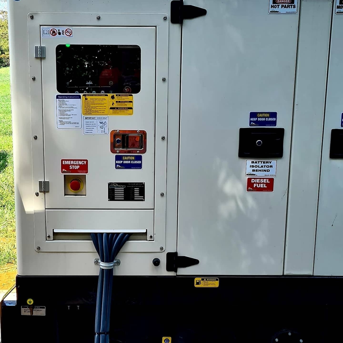 A Beige and Black Electrical Generator Cabinet With a Control Panel — FAW Electrical in Nowra Hill, NSW