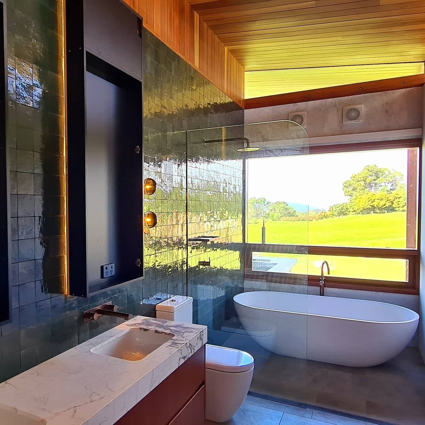 Luxurious Bathroom With Green Tiled Walls — FAW Electrical in Nowra Hill, NSW