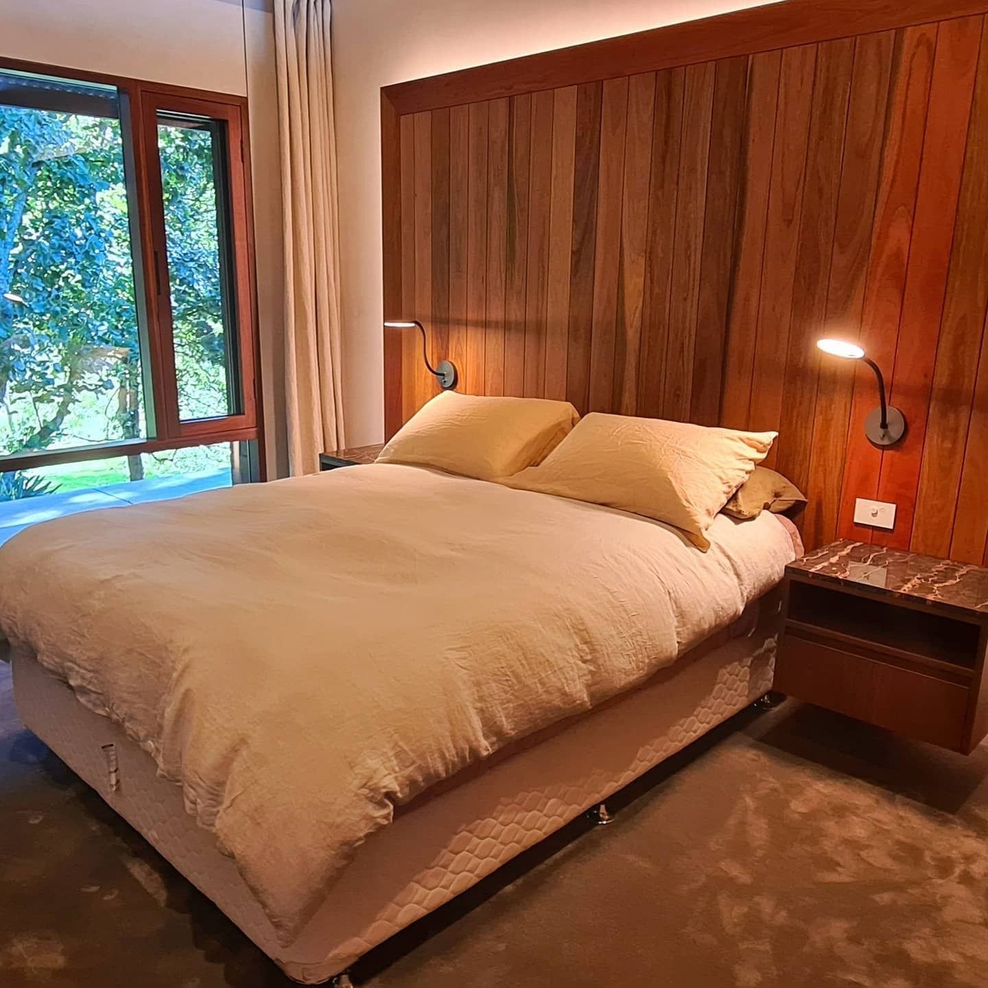 Bedroom With a Wooden Headboard, Double Bed — FAW Electrical in Berry, NSW