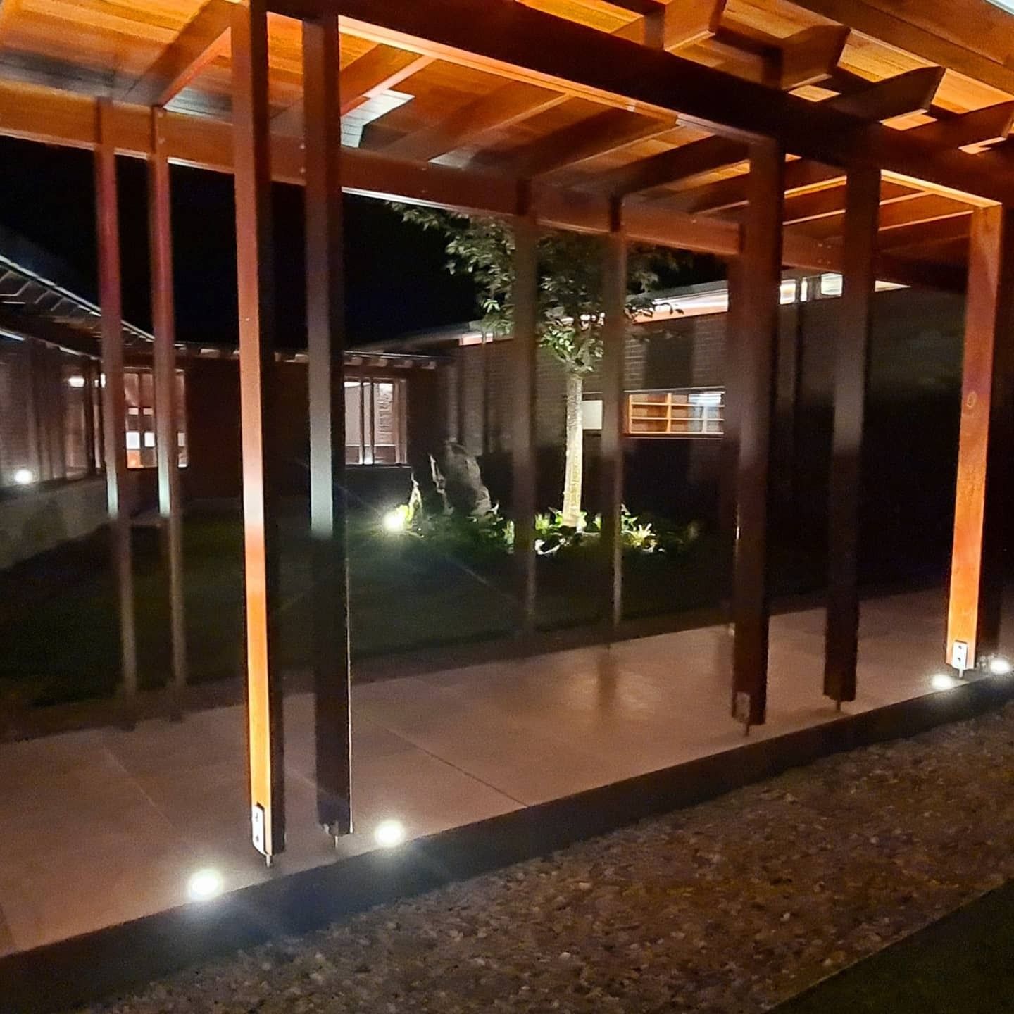 Wooden Pergola Walkway at Night, With Illuminated Ground Lights — FAW Electrical in Nowra Hill, NSW