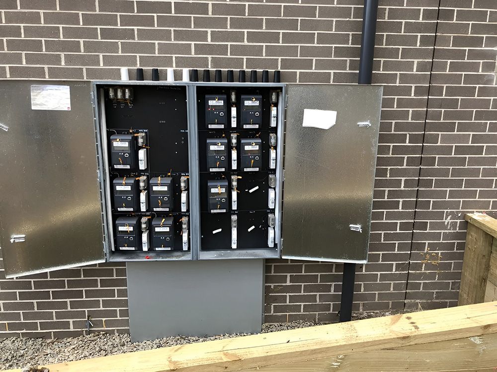 Metal Electrical Meter Box On A Brick Wall — FAW Electrical in Nowra Hill, NSW