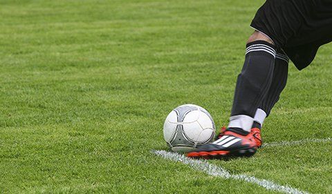 Player Kicking The Ball — Football Clubs in Kingscliff, NSW Player Kicking The Ball — Football Clubs in Kingscliff, NSW