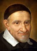 Portrait of Saint Vincent de Paul, a smiling older man in dark robes and a white collar.