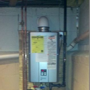 Tankless water heater in a basement.