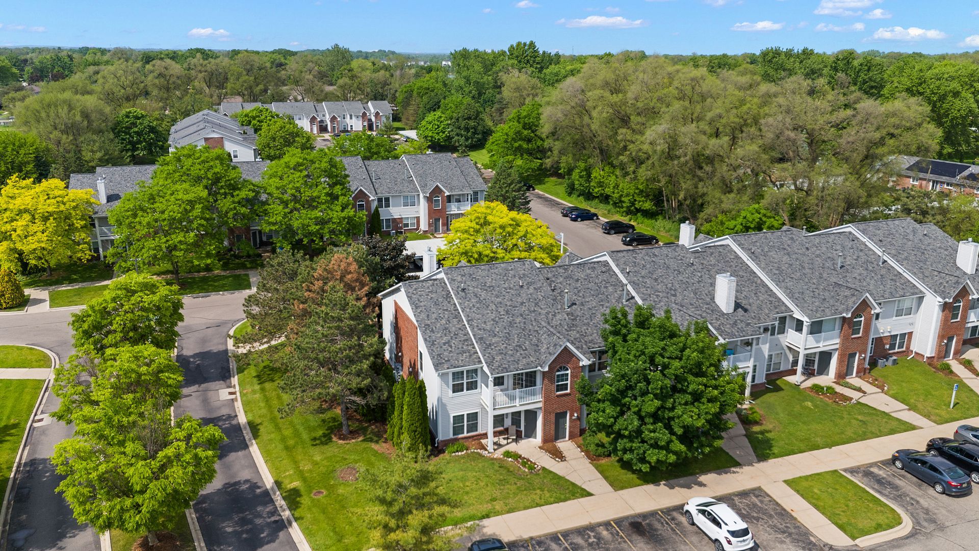 An aerial view of a residential area with a lot of houses and trees.