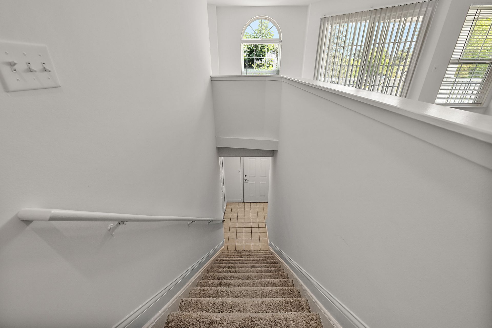 A set of stairs leading up to the second floor of a house.