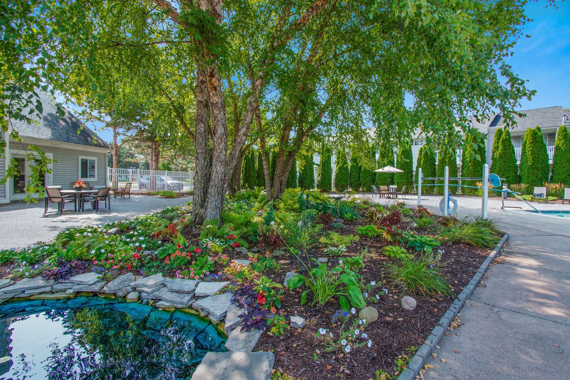 There is a swimming pool in the middle of the garden.