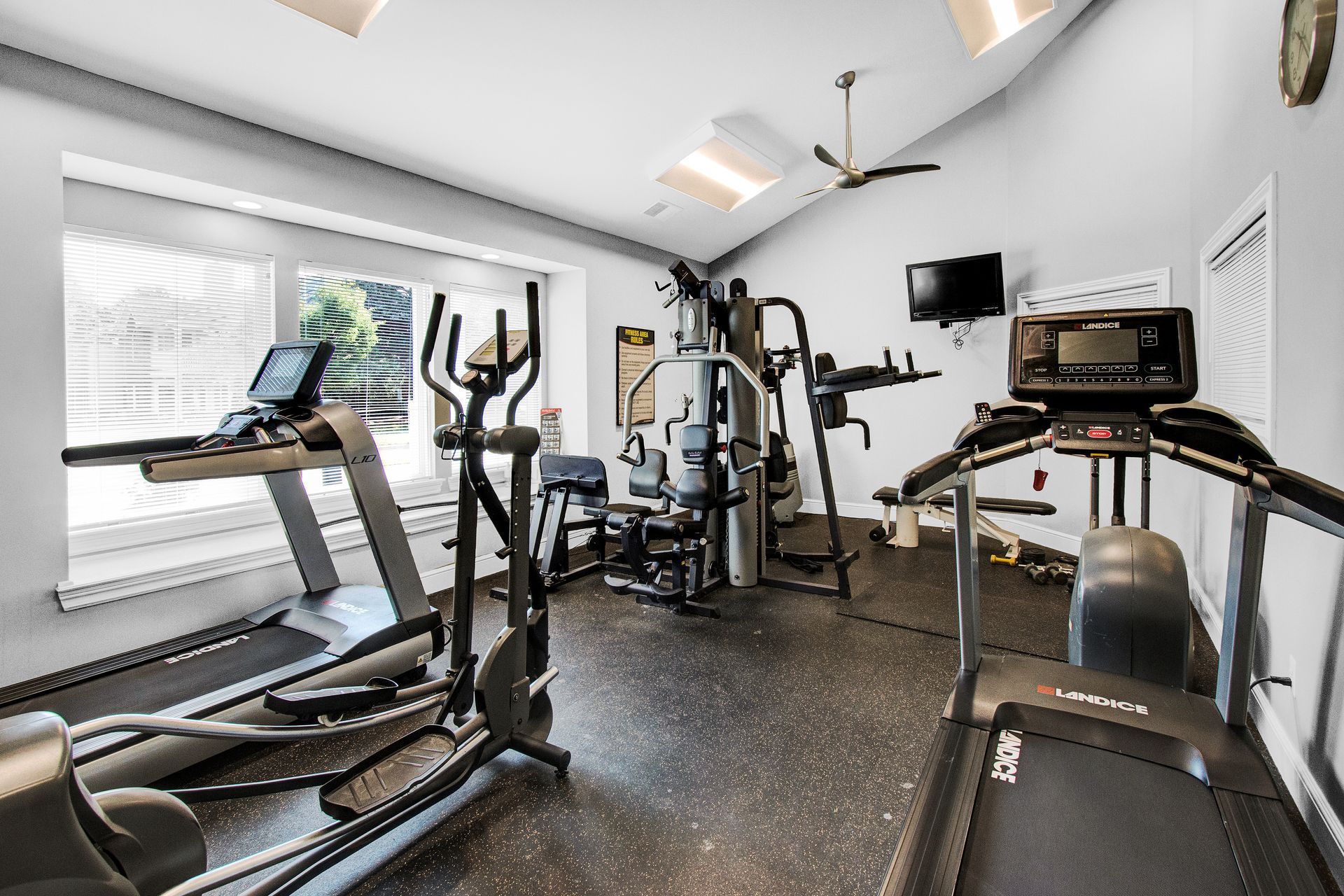 A gym with treadmills , ellipticals , and other exercise equipment.