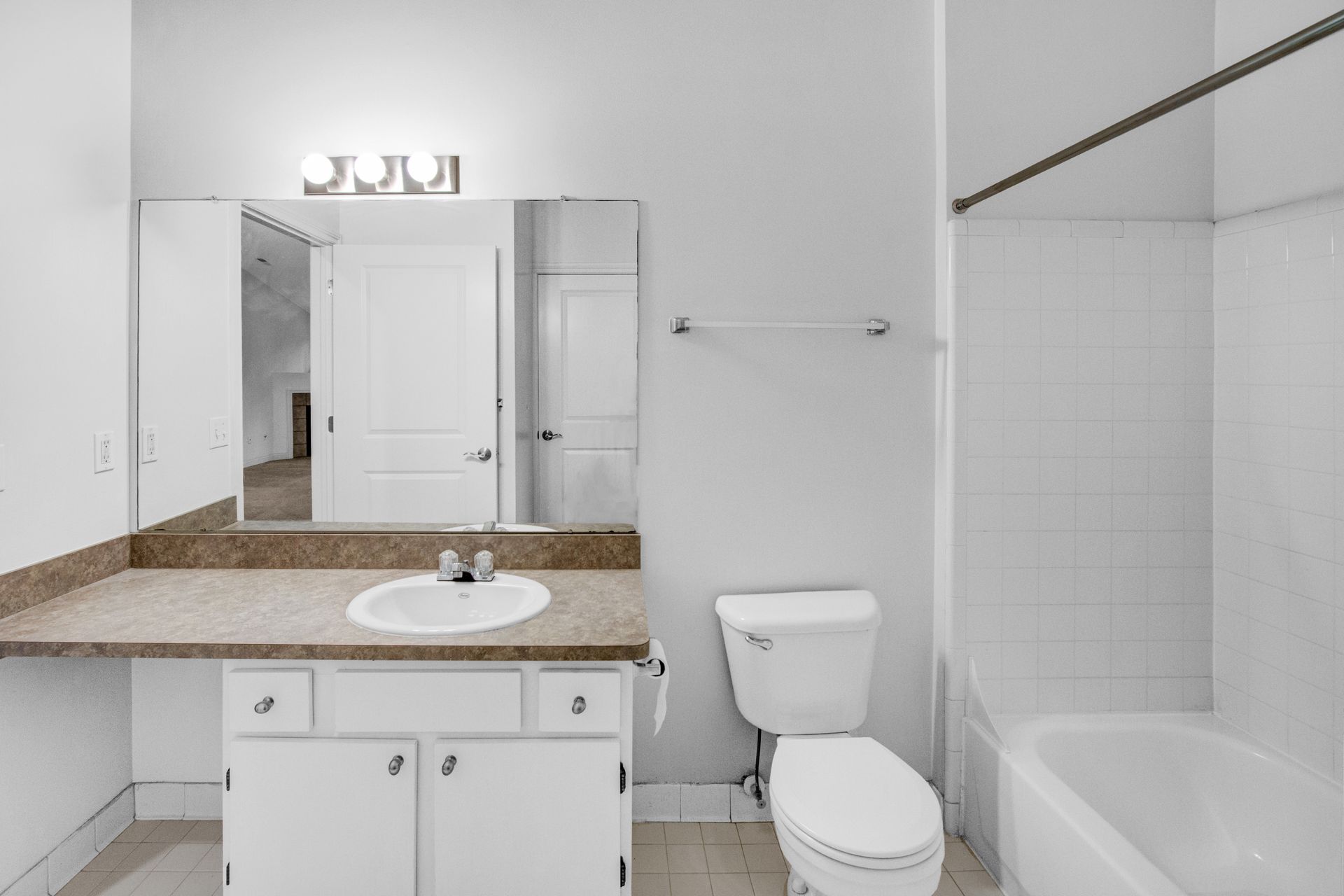 A bathroom with a sink , toilet , and bathtub.
