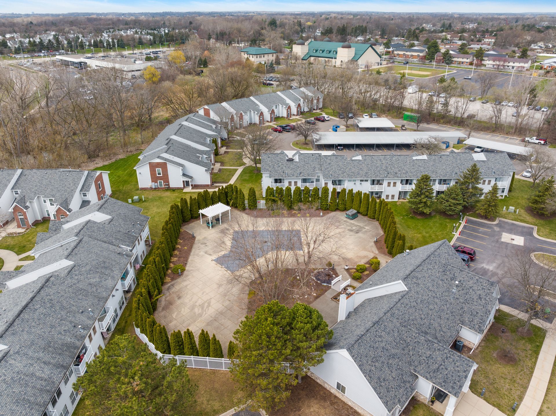An aerial view of a residential area with a lot of buildings and trees.