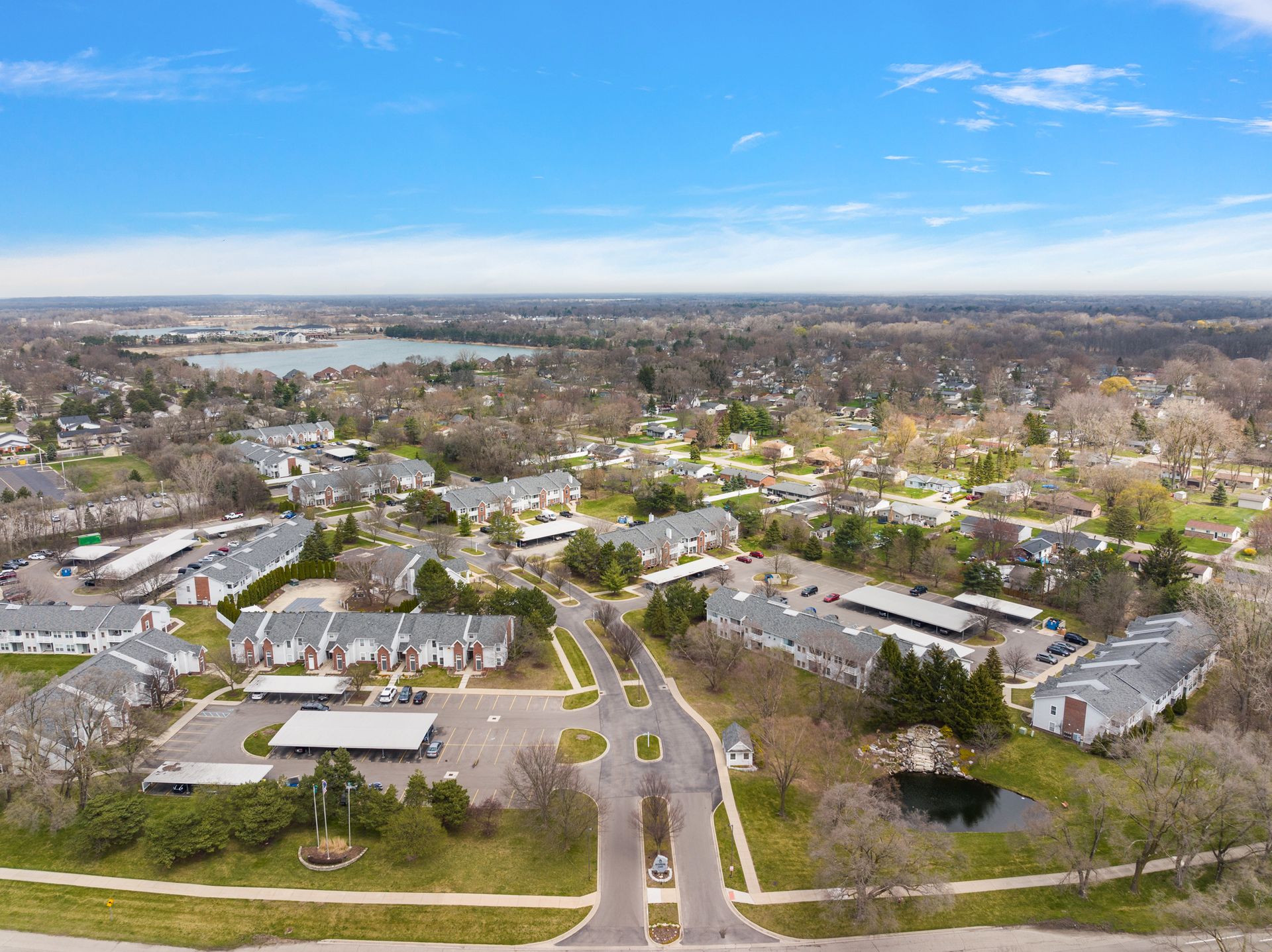 An aerial view of a residential area with a lake in the background.