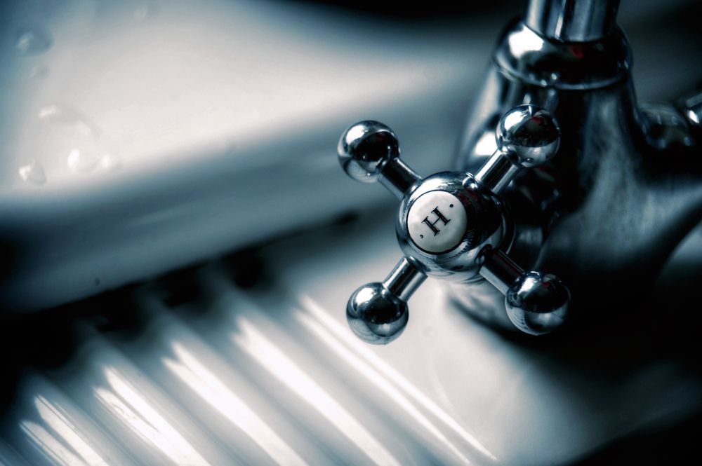 Close-Up Of Chrome Faucet Handle Labelled H Over White Sink — David Talbot Plumbing in Cranbrook, QLD