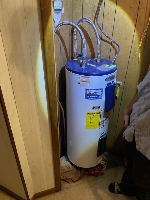 Water Heaters — Man Setting The Water Temperature in Hot Springs, AR