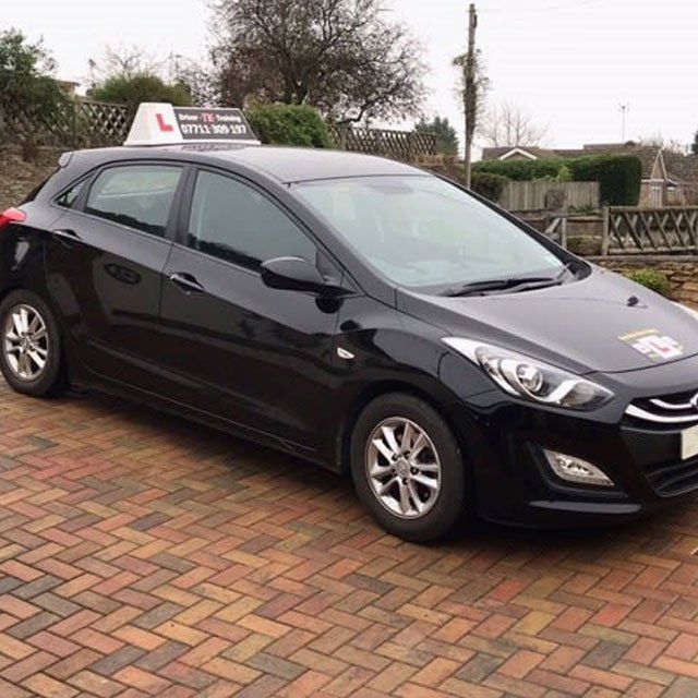 A black car used for driving lessons