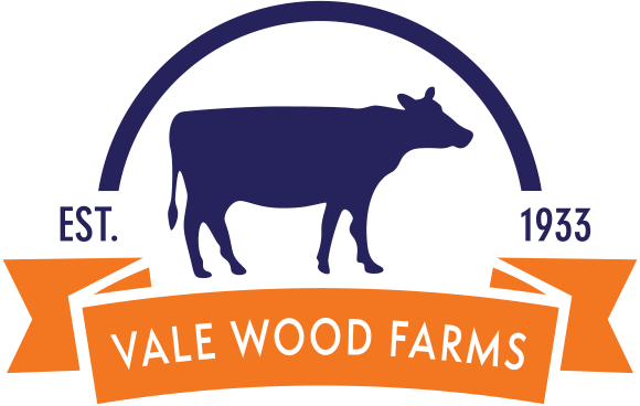 Logo for Vale Wood Farms: Silhouette of a cow in navy blue, arched above, with an orange ribbon below.