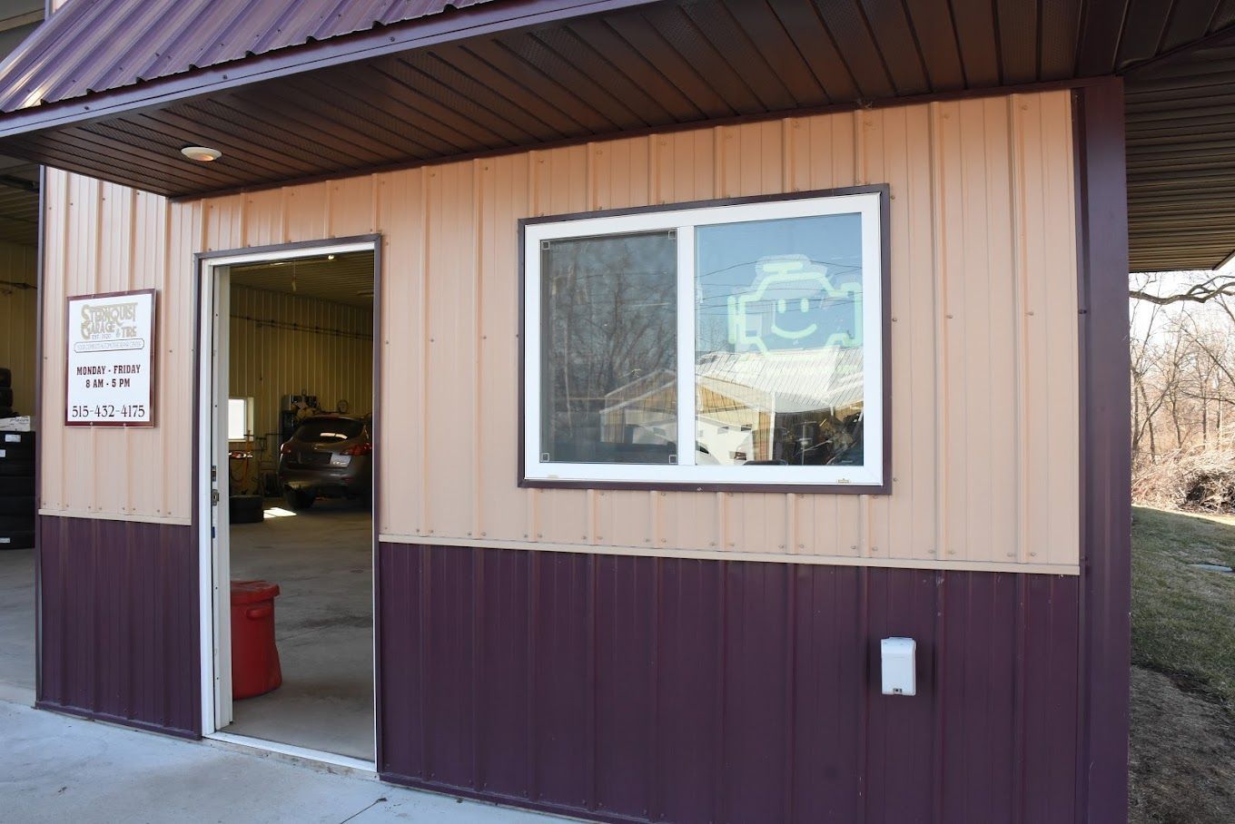 A building with a purple siding and a window with a smiley face on it.