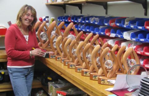 Women standing with trophies