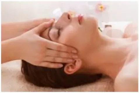A woman is getting a head massage at a spa.