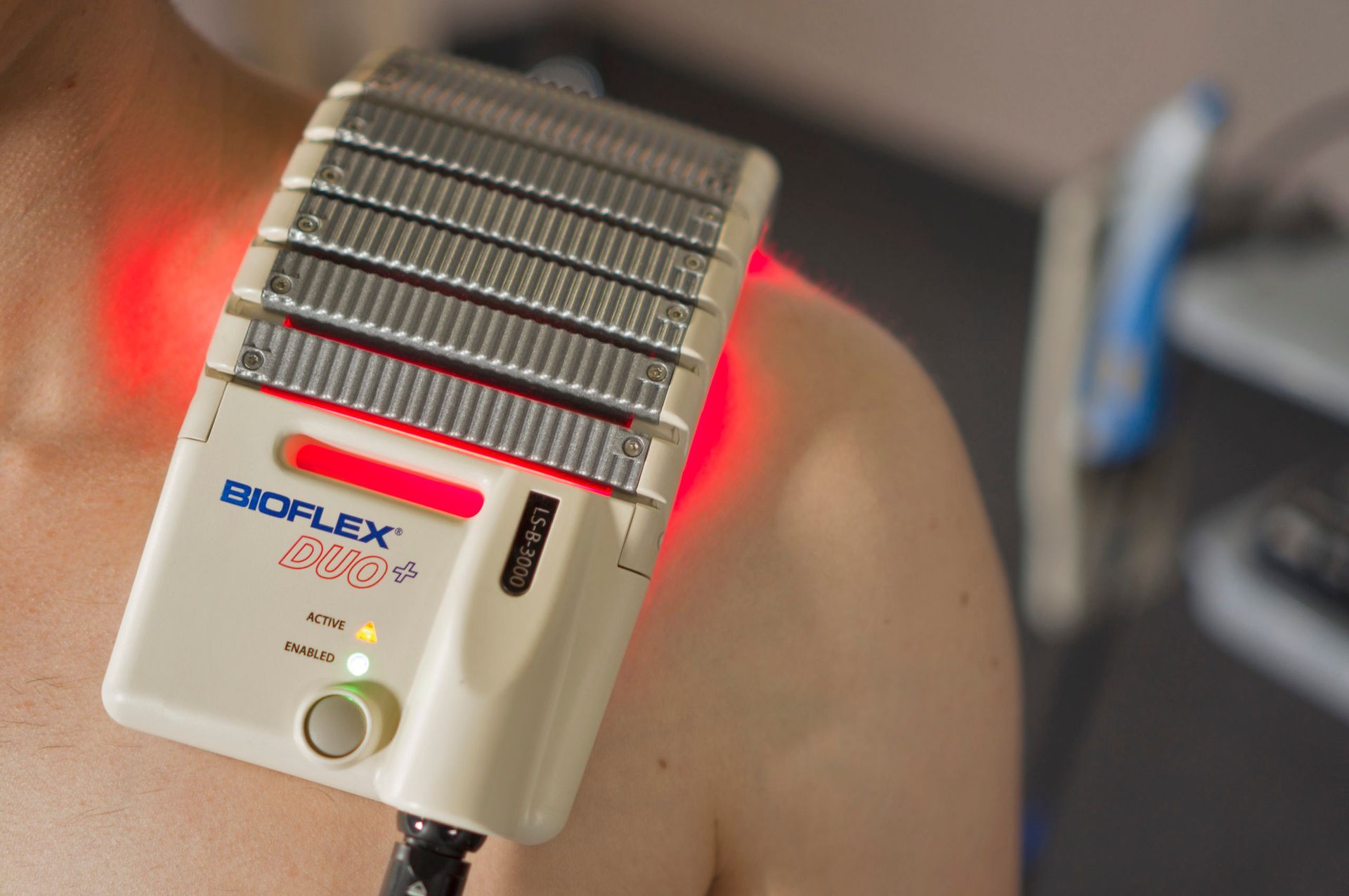 A person is using a bioflex device on their shoulder