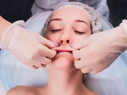 A woman is getting a facial treatment at a beauty salon.