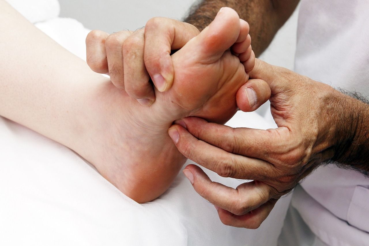 A man is giving a foot massage to a woman