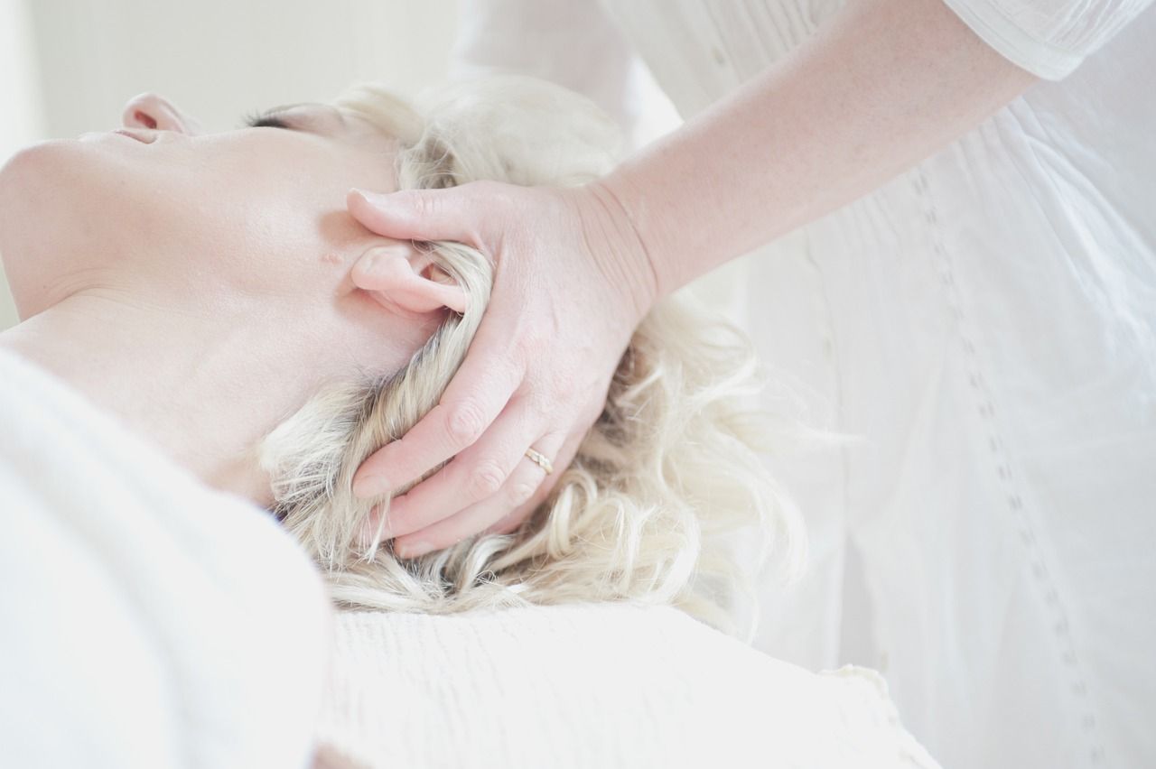 A woman is getting a massage on her head.