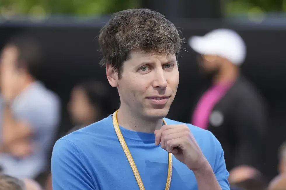 A man in a blue shirt with a yellow lanyard around his neck