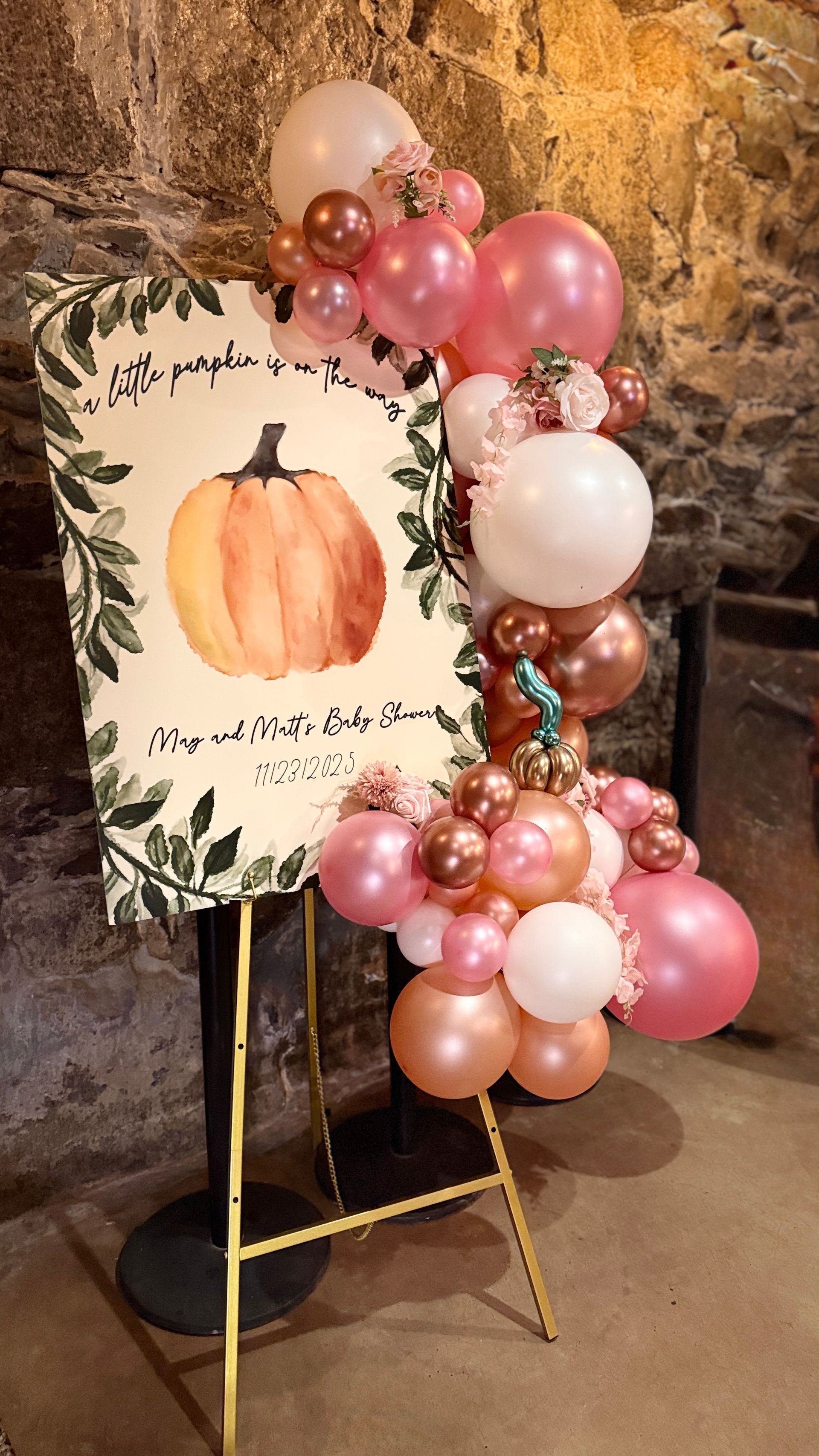 Welcome sign with pumpkin art and pink organic balloon garland.