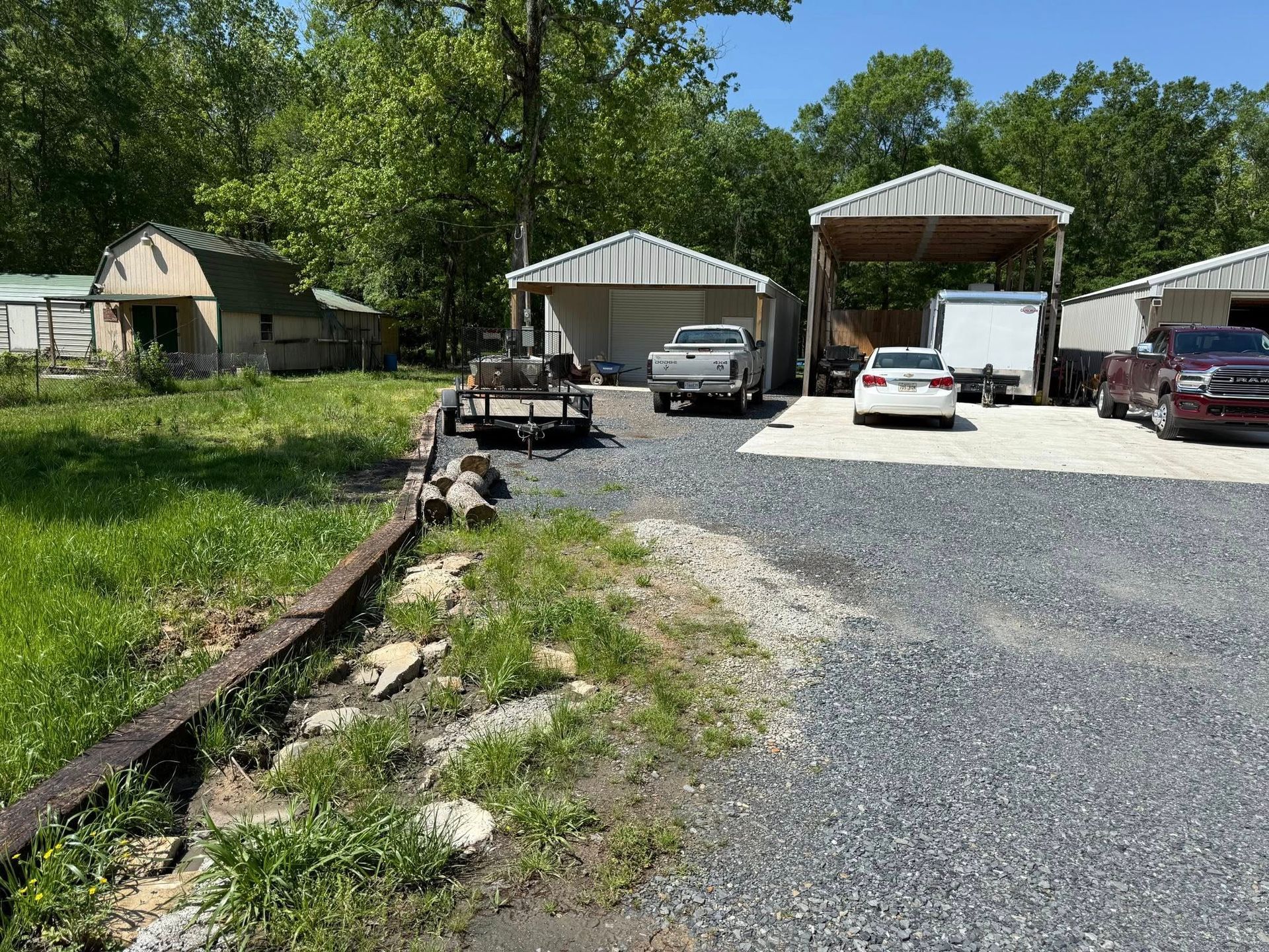 A lot of cars are parked in front of a garage.
