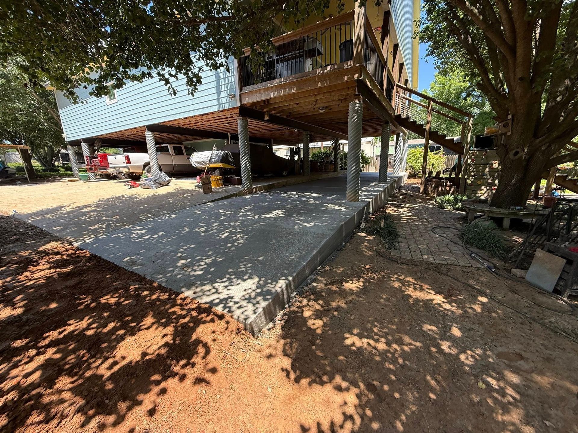 A large house with a concrete driveway underneath it.