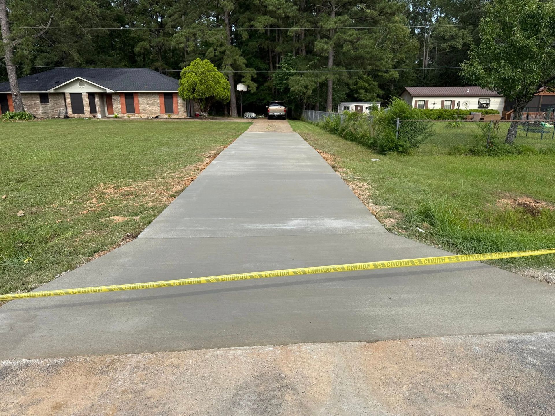 A concrete driveway is being built in front of a house.
