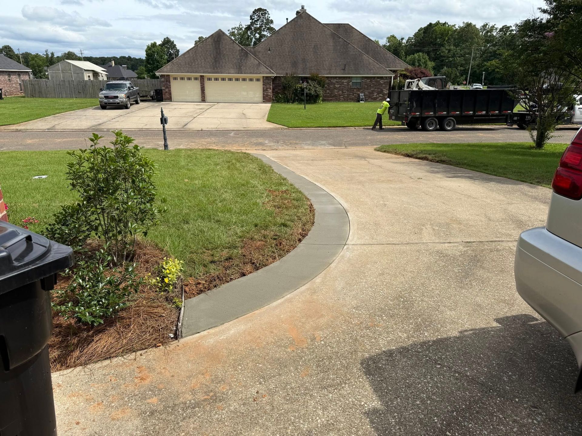 A car is parked in the driveway of a house.