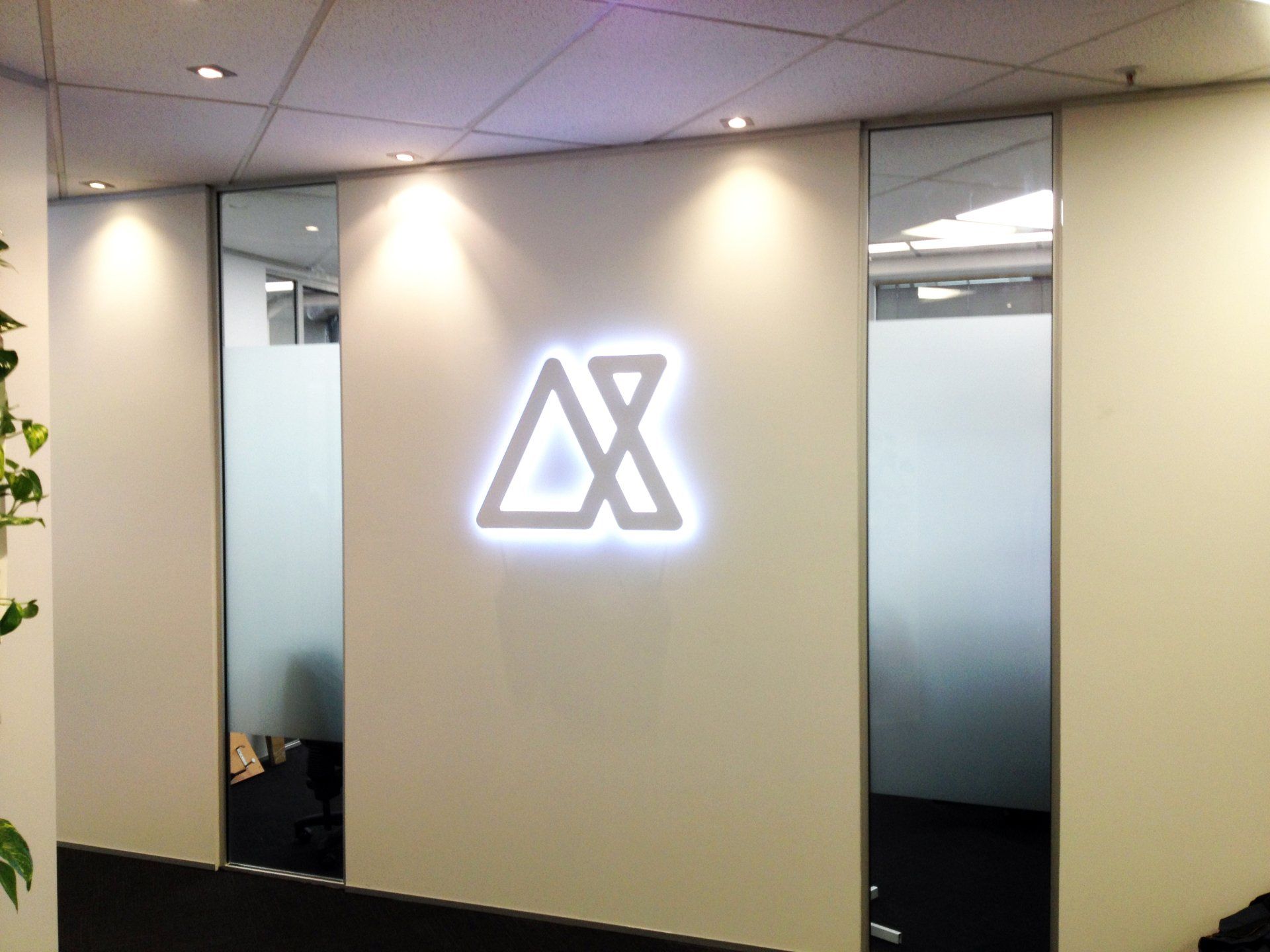 3D office signs  laser cut white acylic logo with LED back lighting installed onto foyer wall