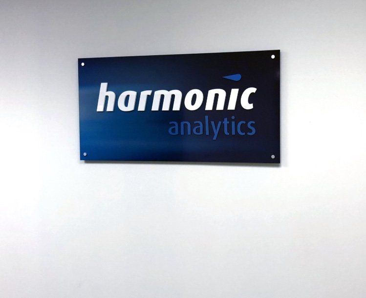 office signs  laser cut acrylic letters mounted onto digitally printed backing panel and installed onto foyer wall using sign mounts