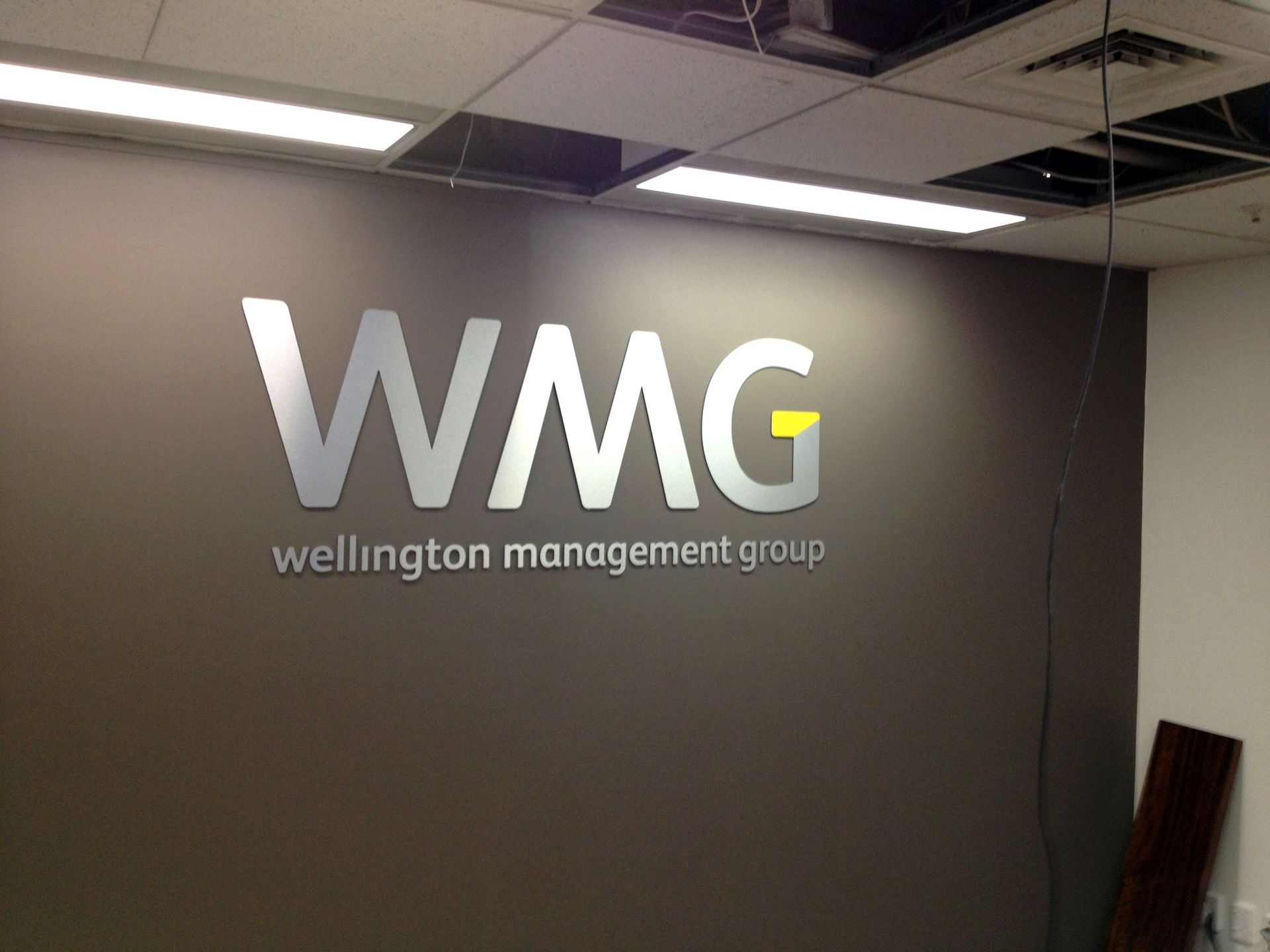 4mm thick laser cut brushed silver ACM letters installed onto office reception wall